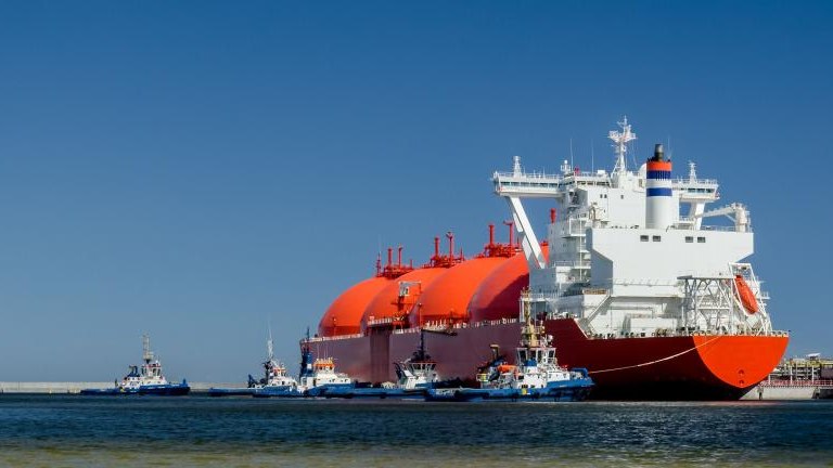 RED LNG TANKER AND SWARM OF TUGBOATS - A giant ship moored to the gas terminal in Swinoujscie shutterstock_1421288093.jpg